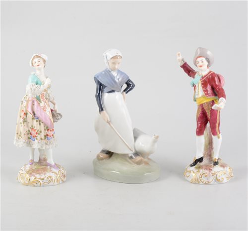 Lot 61 - A pair of continental figures depicting a man and a woman, 18.5cm tall and a Royal Copenhagen Goose Girl figure, 18.5cm tall. (3)