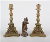 Lot 194 - A pair of 19th century continental brass candlesticks, 21cm tall, 11cm wide, and a small bronze figure depicting St Christopher carrying the Christ child, 13cm tall. (3)