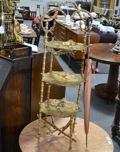 Lot 176 - A bamboo three tier cake stand with pierced gold painted trays, 96cm, a vintage parasol with horn handle and dust cover.