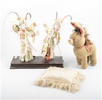 Lot 178 - A beaded pin cushion "May God Protect .....", pair of Japanese dancing figures in costume, plush donkey with velvet ears, kid leather saddle. (4)