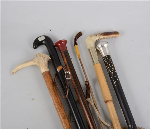 Lot 166 - A collection of canes and crops, a Bagnall hunting crop, a cane with silver coloured top, stags horn walking stick, etc.