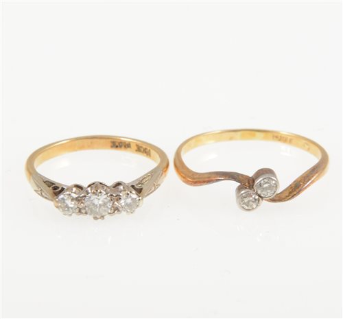 Lot 209 - Two diamond rings - a diamond three stone ring, the brilliant cut stones graduating in size claw set in a yellow and white metal traditional three stone mount