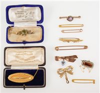 Lot 271 - Eleven Victorian and later brooches, a 15 carat yellow gold frost gilded etruscan style bar brooch 40mm long with locket back, hallmarked Chester 1896