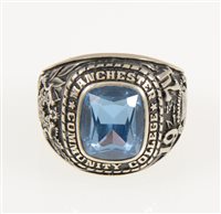 Lot 227 - An American college ring "Manchester Community College 1974" set with a rectangular synthetic blue spinel, shank marked 10K Jostens, gross weight approximately 19.2gms, ring size R.