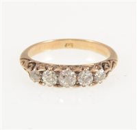 Lot 210 - A diamond five stone ring, the old brilliant cut diamonds graduating in size and claw set in an all yellow metal carved claw mount, ring size J.