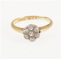 Lot 214 - A circular diamond cluster ring, seven old eight cut diamonds milgrain set in a yellow and white metal mount, shank marked 18, ring size O.