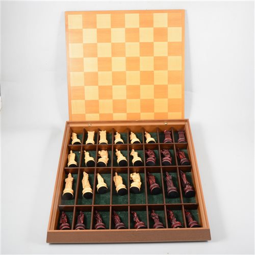 Lot 86 - A modern resin chess set in the Chinese Imperial style in fitted wooden case with integral board