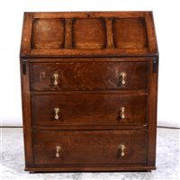 Lot 527 - Reproduction oak bureau, panelled fall front, enclosing part fitted interior, three long drawers under, lacking feet, width 74cm.