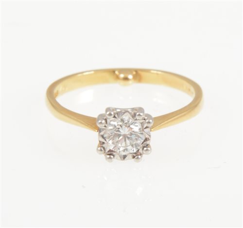 Lot 207 - A diamond solitaire stone ring, the brilliant cut stone illusion set and having four double claws in an 18 carat yellow gold and platinum mount