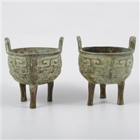 Lot 75 - Pair of archaic style Chinese patinated bronze tripod censers