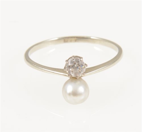 Lot 224 - A pearl and diamond two stone ring, a 5.2mm pearl and small old cut diamond set vertically on an all white metal mount marked 18ct on shank, ring size Q.