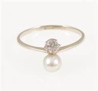 Lot 224 - A pearl and diamond two stone ring, a 5.2mm pearl and small old cut diamond set vertically on an all white metal mount marked 18ct on shank, ring size Q.