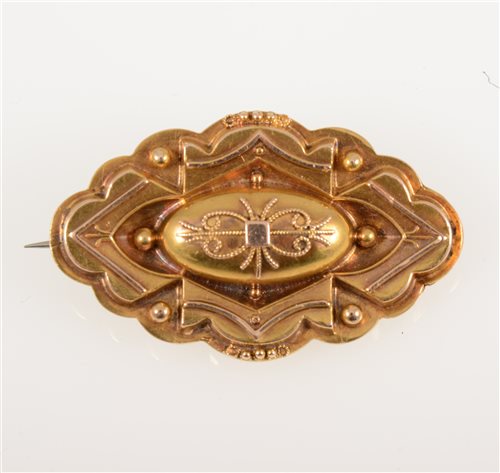 Lot 268 - A Victorian yellow metal target brooch with etruscan wire work decoration, 40mm x 25mm, marked 15ct