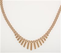 Lot 245 - A 9 carat yellow gold fringe necklace, the bark textured bars tapering from 15mm to 2mm and supported by a three row bar link collar 46cm long, hallmarked Birmingham 1977, approximate weight 25.4gms.