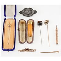 Lot 350 - A small gold coloured propelling pencil, amber cigarette holder with GP collar, five stickpins/ brooches, one in fitted case marked 15ct