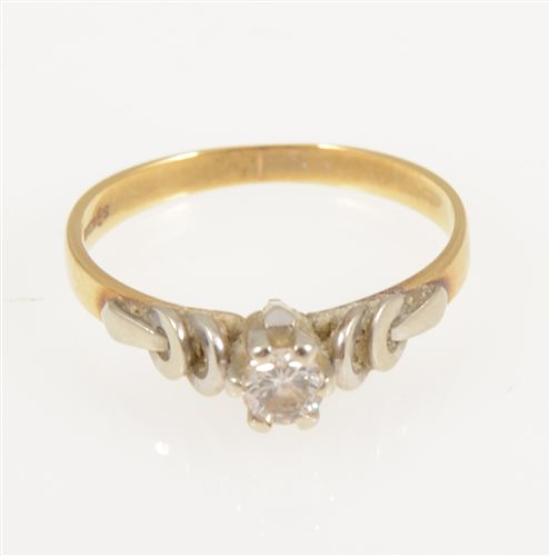 Lot 238 - A diamond solitaire ring, the brilliant cut stone claw set in an 18 carat yellow and white gold mount with raised white gold shoulders