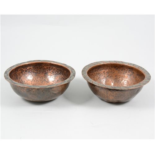 Lot 80 - Hugh Wallis, Arts and Crafts, two copper bowls with copper and white metal chevron edging, hand beaten and unpolished finish, stamped HW. (2)