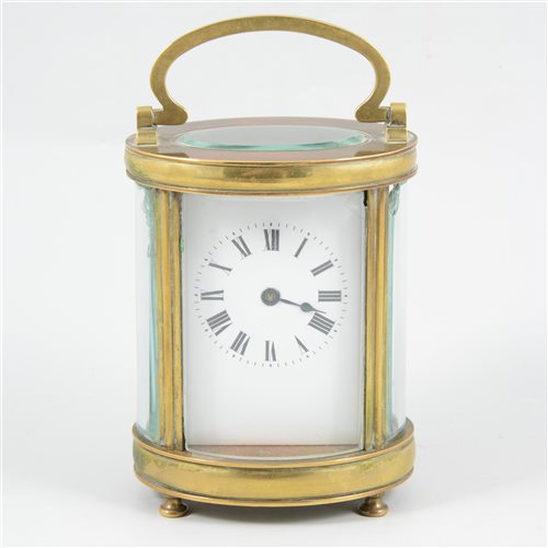 Lot 83 - An oval brass cased carriage clock, with bevel glass panels.