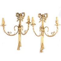 Lot 156 - Set of four French Empire inspired gilt metal two-light wall sconces (some damage).