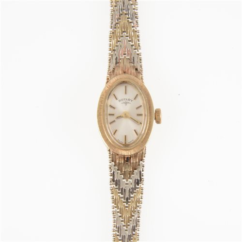 Lot 323 - Rotary - a lady's 9 carat gold bracelet watch, the oval baton dial in a 9 carat yellow gold case with bark textured bezel