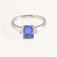 Lot 252 - A tanzanite and diamond ring, the square cut tanzanite 7.9mm x 6mm, four claw set in a platinum mount with a baguette cut diamond to each shoulder