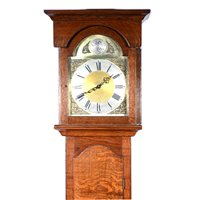 Lot 456 - Reproduction oak longcase clock, arched brass dial with silvered chapter ring, German weight driven movement, plain oak case with a long door, 205cm.