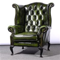 Lot 491 - Traditional style close studded green leather wing-back easy chair, on cabriole legs, width 93cm.