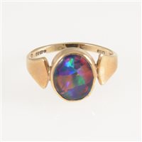 Lot 269 - An opal dress ring, the oval cabochon cut opal triplet, 11mm x 9mm, collet set in a 9 carat yellow gold mount with wide polished shoulders, ring size P.