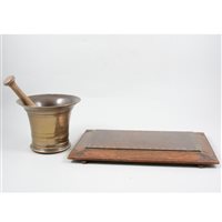 Lot 171 - Bronze bell-shape mortar, perhaps 18th Century, 13cm; stoneware and beech pestle; and a copper-faced oak plaque (3)