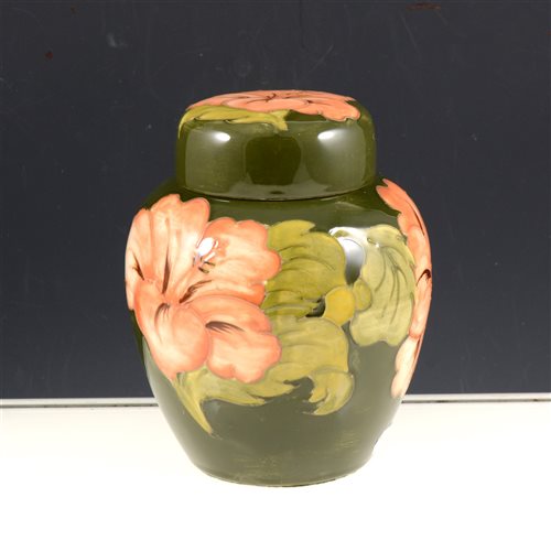 Lot 49 - Moorcroft ginger jar, Hibiscus design, on a green ground, 17cm.