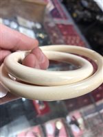 Lot 196 - Two early 20th Century ivory bangles, monkey design.