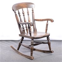 Lot 461 - Child's stained wood rocking chair, spindle-back, open arms, solid seat, width 39cm.