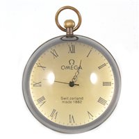 Lot 213 - A globe pendant desk clock signed Omega, 9cm.