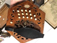 Lot 174 - An Anglo concertina squeezbox by Lachenal & Co of London, twenty-nine buttons, pierced mahogany case