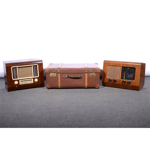Lot 531 - Pye model P35 walnut cased mains radio, width 51cm; an HMV model 1119 mains radio; and an Orient make cloth trunk, (3).