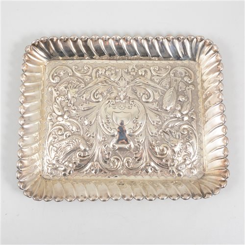 Lot 185 - A silver tray by Army & Navy Cooperative Society Ltd, repousse chased decoration with vacant cartouche in centre and lion's head below, surrounded by flowers, birds and figurative representations o...