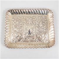 Lot 185 - A silver tray by Army & Navy Cooperative Society Ltd, repousse chased decoration with vacant cartouche in centre and lion's head below, surrounded by flowers, birds and figurative representations o...