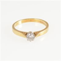 Lot 264 - A diamond solitaire ring, the brilliant cut stone claw set in an 18 carat yellow and white gold mount hallmarked London, approximate weight of diamond 0.12 carat, ring size K.