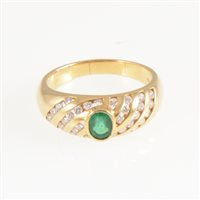 Lot 243 - An emerald and diamond dress ring, the oval mixed cut emerald collet set in an all yellow metal domed shape mount marked 750
