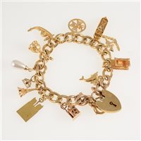 Lot 285 - A 9 carat yellow gold solid filed curb link charm bracelet with padlock fastener, twelve charms attached, some marked 750, 14K, approximate weight 46gms