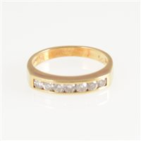 Lot 261 - A diamond half eternity ring, seven brilliant cut diamonds channel set in an 18 carat all yellow gold half eternity mount