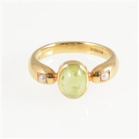 Lot 249 - A peridot and pearl dress ring, an oval cabochon cut peridot collet set with a seed pearl to each side in an 18 carat all yellow gold mount