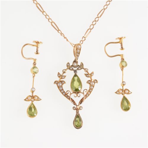 Lot 295 - An Edwardian peridot and seed pearl pendant 40mm, set with pear shaped stones, marked 15ct on back