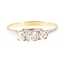 Lot 203 - A diamond three stone ring, the old cut stones graduated in size square set in a yellow and white metal traditional three stone mount, the shank marked 18ct, ring size N.