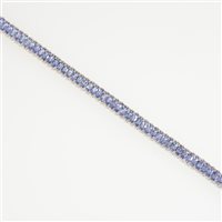 Lot 283A - An 18 carat white gold line bracelet set with seventy-one marquise cut tanzanites, each 5mm x 2.5mm, spaced by pairs of small brilliant cut diamonds (one hundred and forty-two in total )