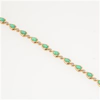 Lot 281 - An emerald and diamond line bracelet, eighteen pear shaped emeralds individually claw set and spaced by seventeen small diamonds in 18 carat yellow gold, overall width 4.8mm, length 19cm