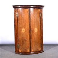 Lot 424 - George III oak and mahogany cylinder front hanging corner cupboard.