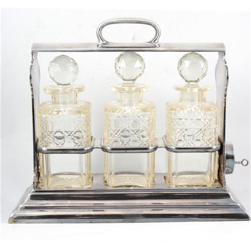 Lot 158 - Walker & Hall silver plated three-bottle tantalus, with key.