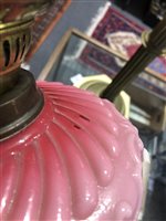 Lot 140 - Edwardian brass oil lamp, pink opalescent reservoir