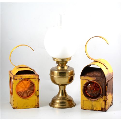 Lot 134 - Three yellow enamelled Chalwyn road lamps and a brass oil lamp (4).